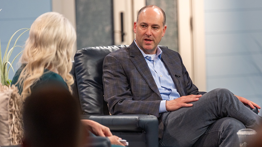 Adam Symson seated in conversation with KNXV general manager Anita Hecht