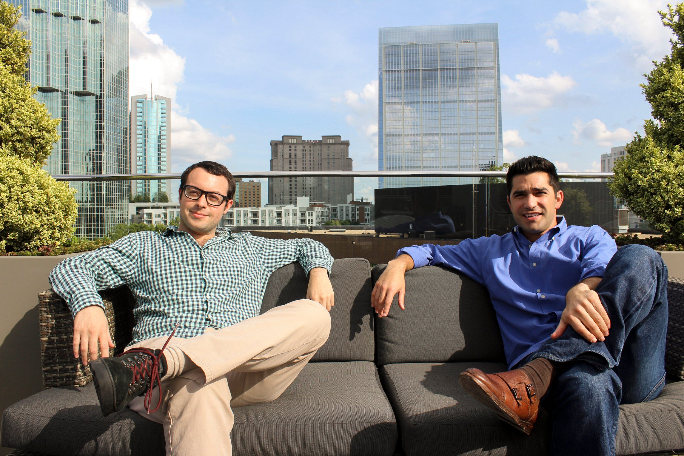 Sam Solomon and Adam Wexler seated on a rooftop couch in Atlanta