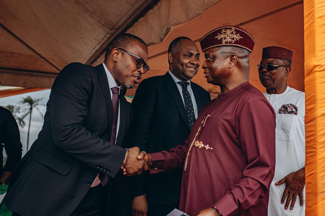 Adeniran Ajakaiye, left, greeting an attendee at the May 2024 student housing launch