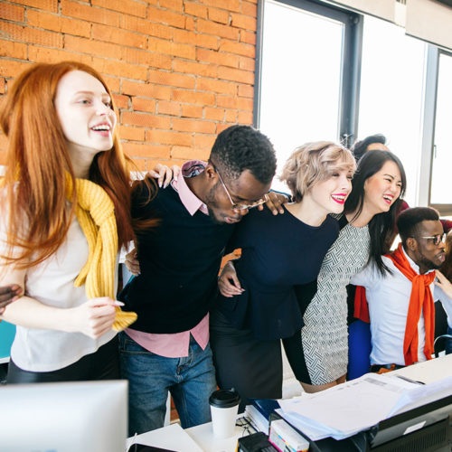 A group gathered around a desk in Aderant’s careers-page photography