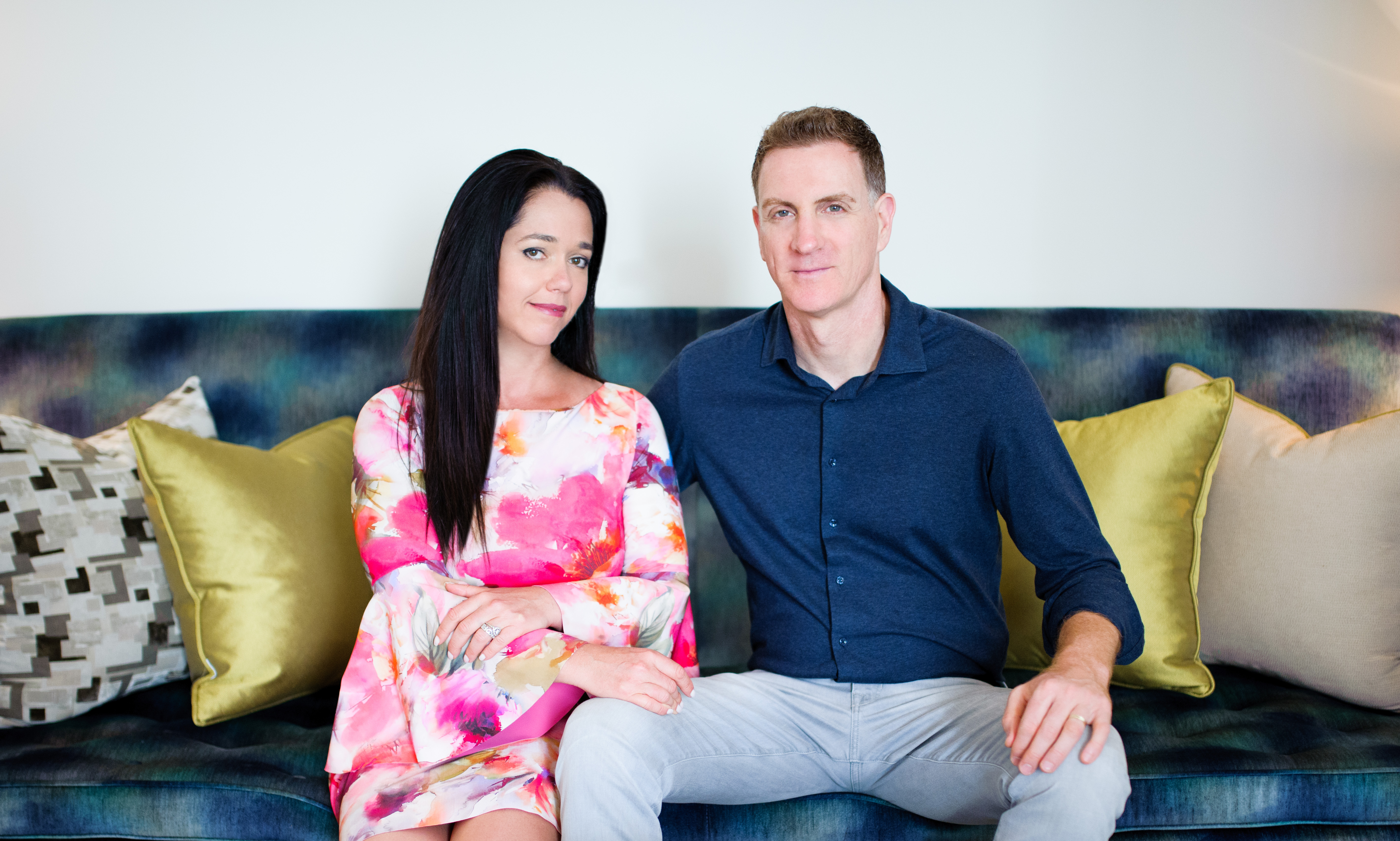Adi Tatarko and Alon Cohen sitting together on a sofa