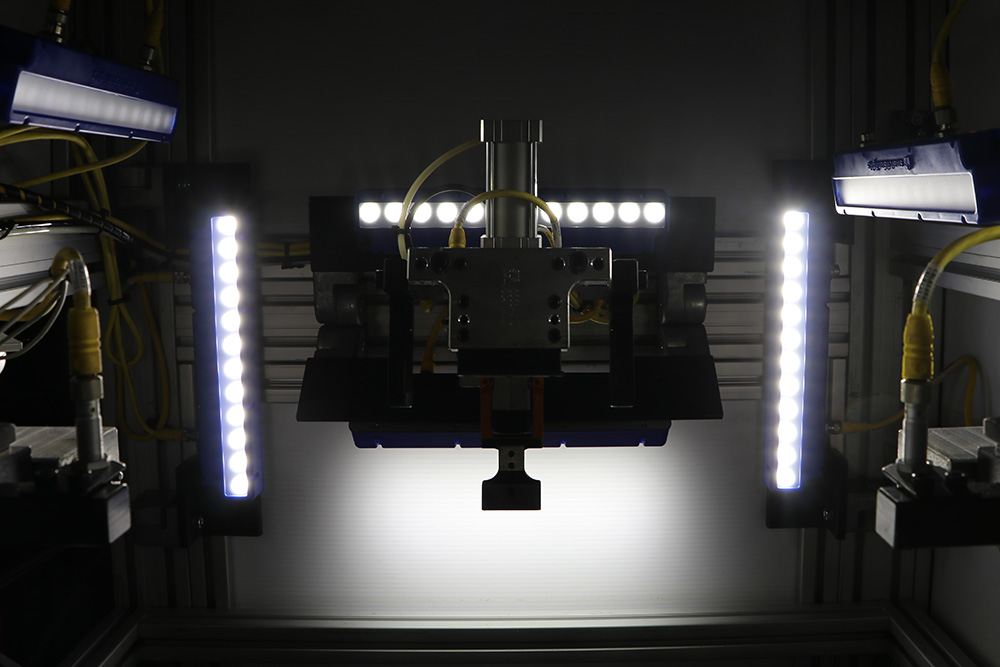 Illuminated industrial welding inspection equipment in an Adient manufacturing image