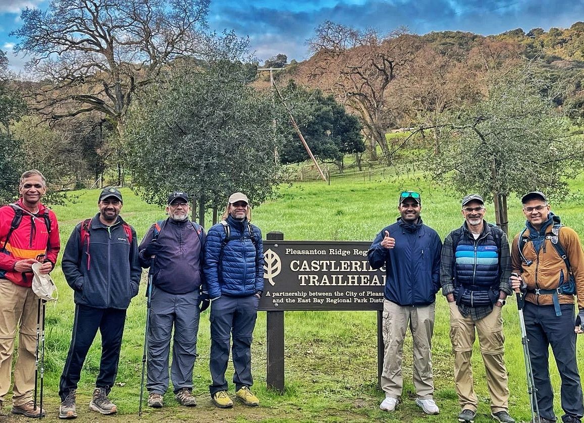 Adnan Lawai and fellow hikers with Asad Ali Memon beside the Castleridge trailhead sign