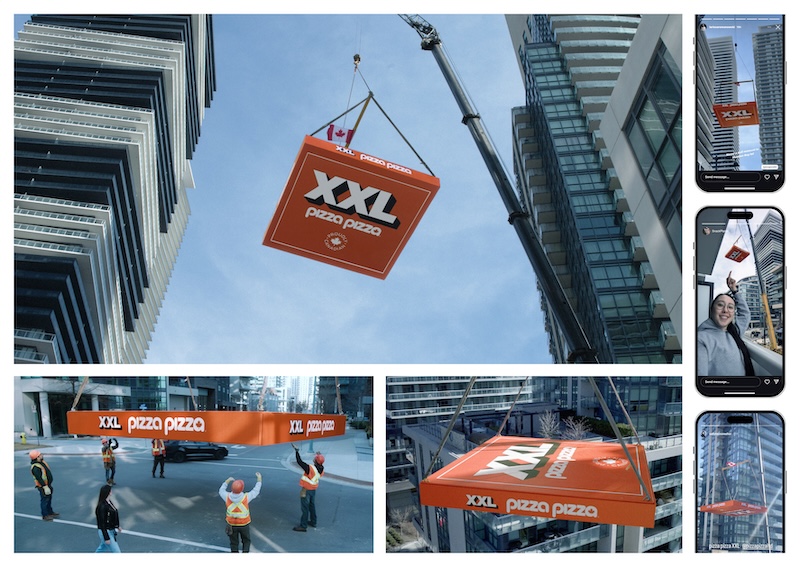 A giant Pizza Pizza box suspended by a crane above a Toronto neighbourhood