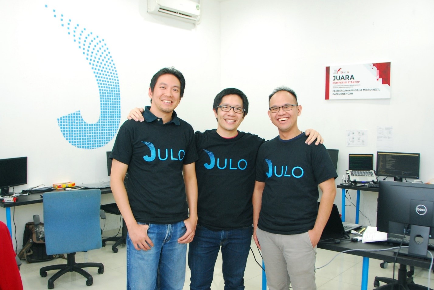 JULO co-founders Victor Darmadi, Adrianus Hitijahubessy and Hans Sebastian standing together in their office
