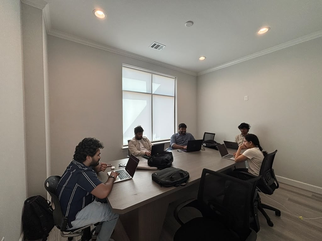 Adroit team members working on laptops around a conference table