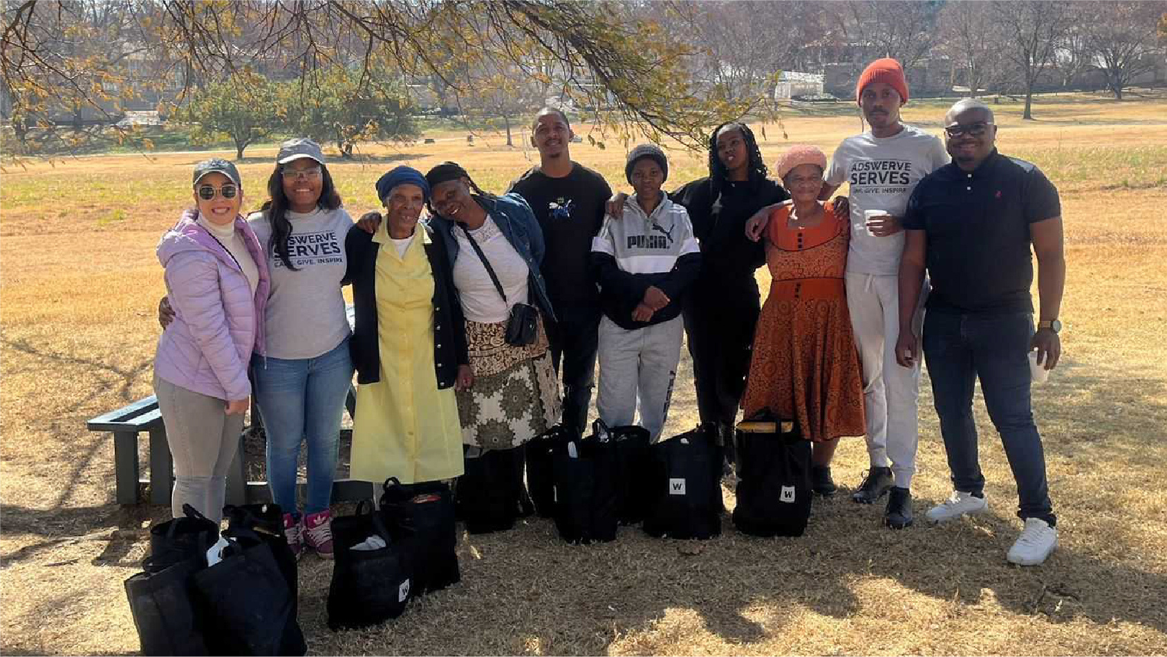 Group photograph from Adswerve’s company culture page, outdoors in a park
