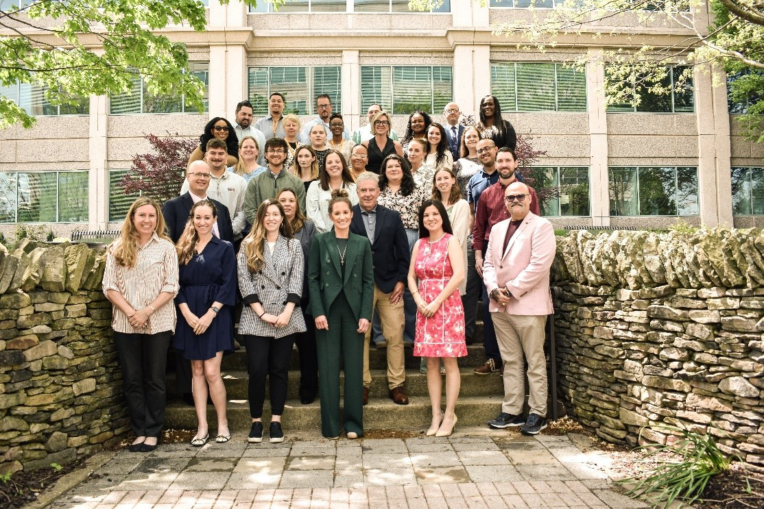 ACH colleagues gathered on outdoor steps for a company group photograph