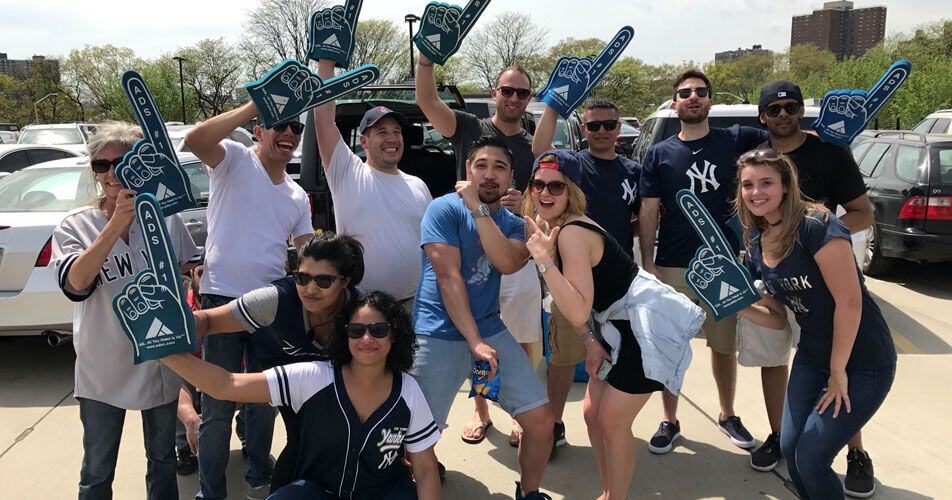 ADS employees holding foam fingers during a Yankees outing