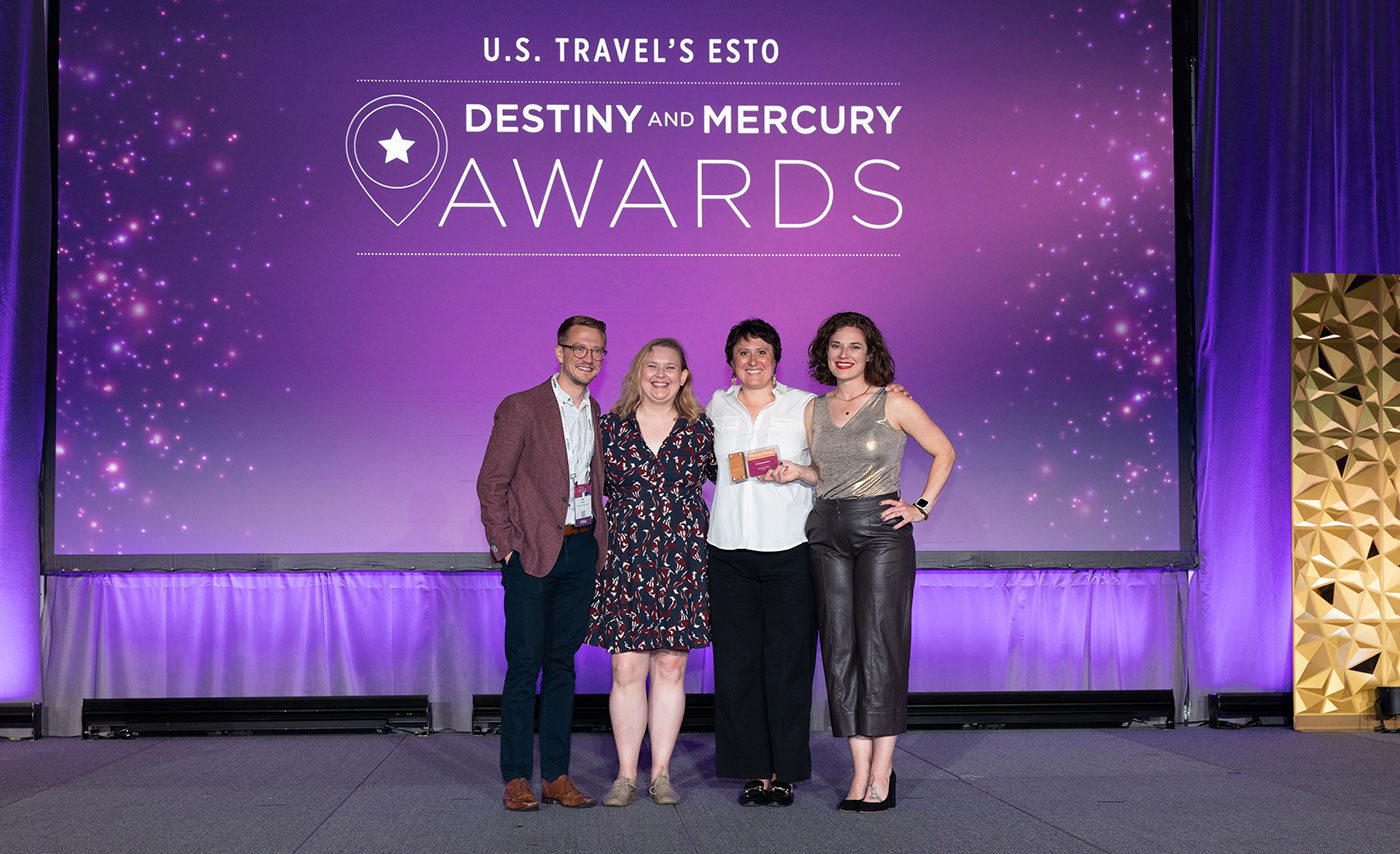 Adventure and Explore Minnesota representatives holding a Mercury Award at the 2024 ESTO ceremony