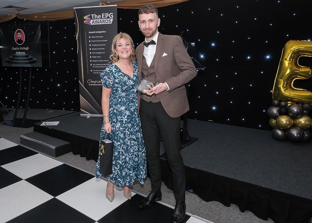 Two attendees holding an award at the 2024 Empowering People Group awards