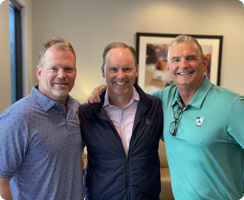 Three Advizex employees smiling together at a company event