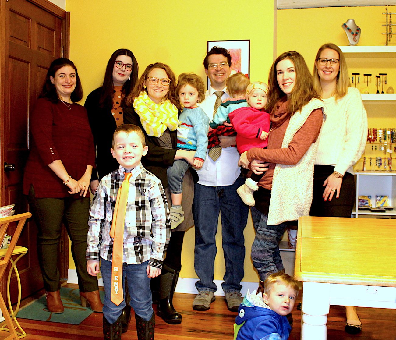 Members of the Advokate team and their children gathered in the studio in 2018