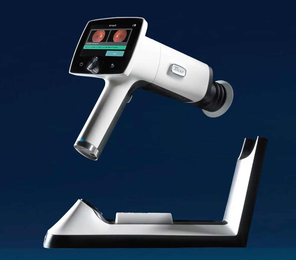 Optomed Aurora AEYE handheld retinal camera on its charging stand