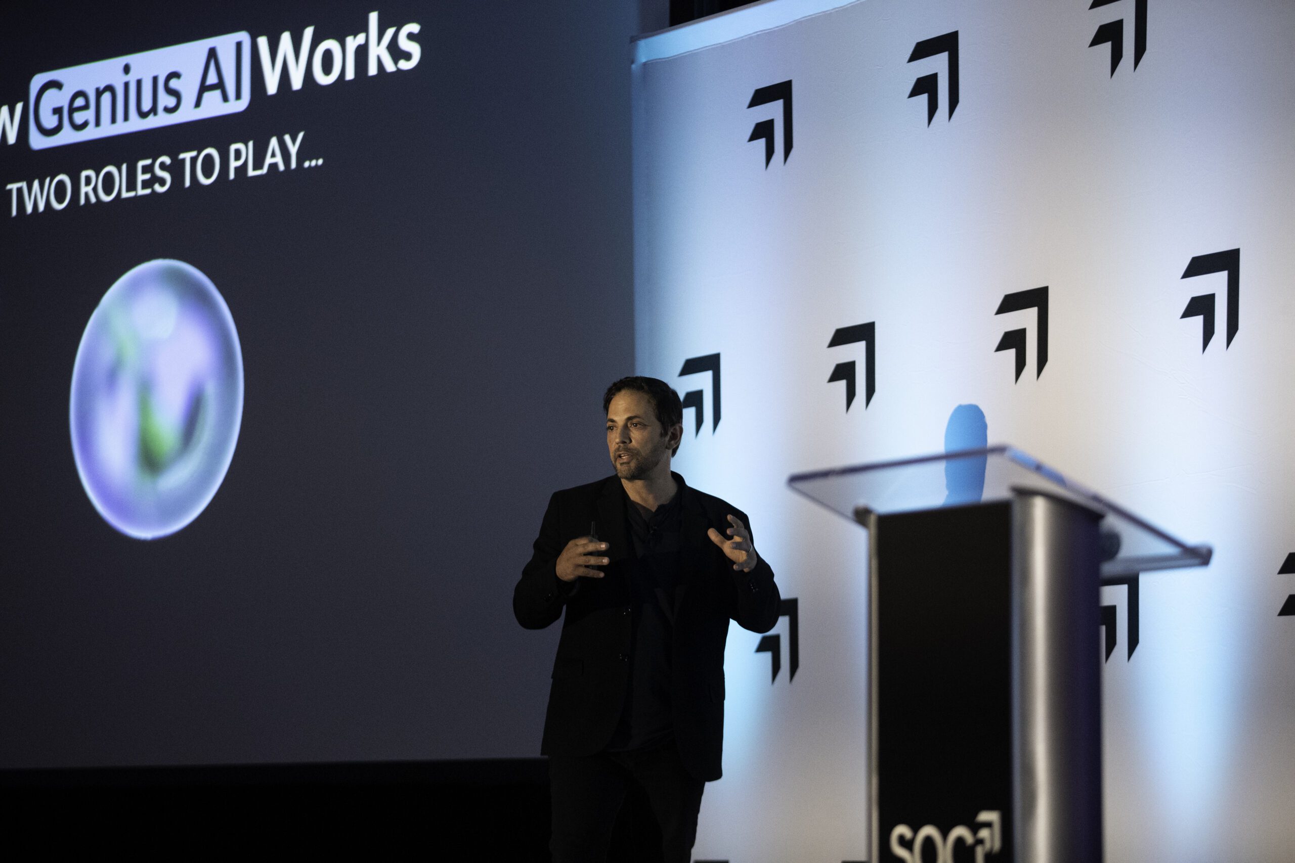 Afif Khoury presenting beside a Genius AI screen at SOCi ReImagine 2024