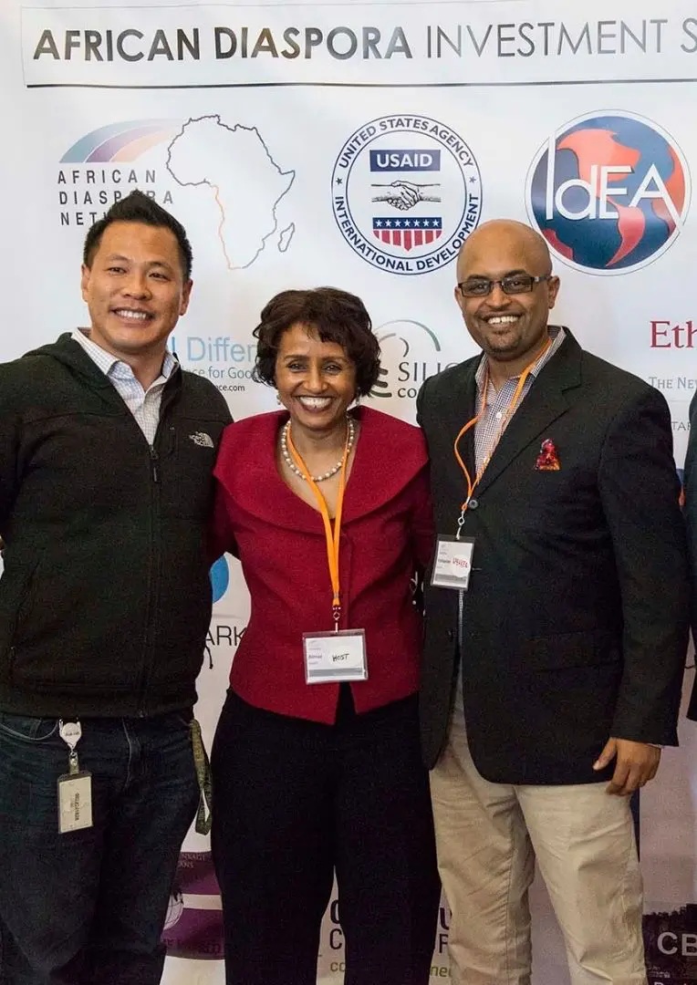 Almaz Negash, center, with fellow attendees in an archival African Diaspora Investment Symposium photograph