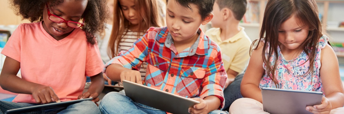 Young children using ABCmouse on tablets in a classroom