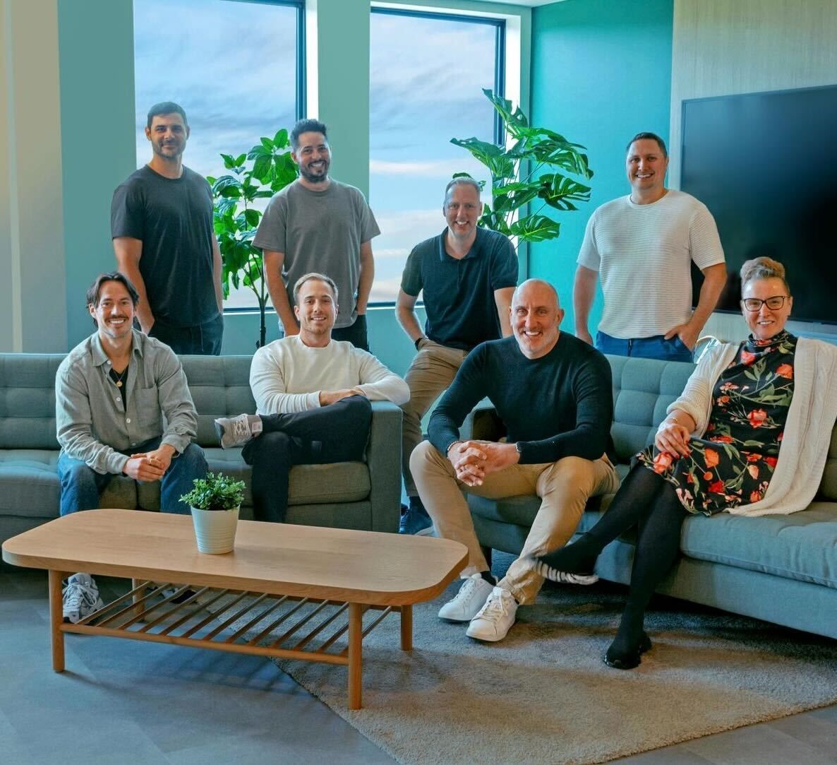 Members of the Agendrix team gathered in a bright office lounge