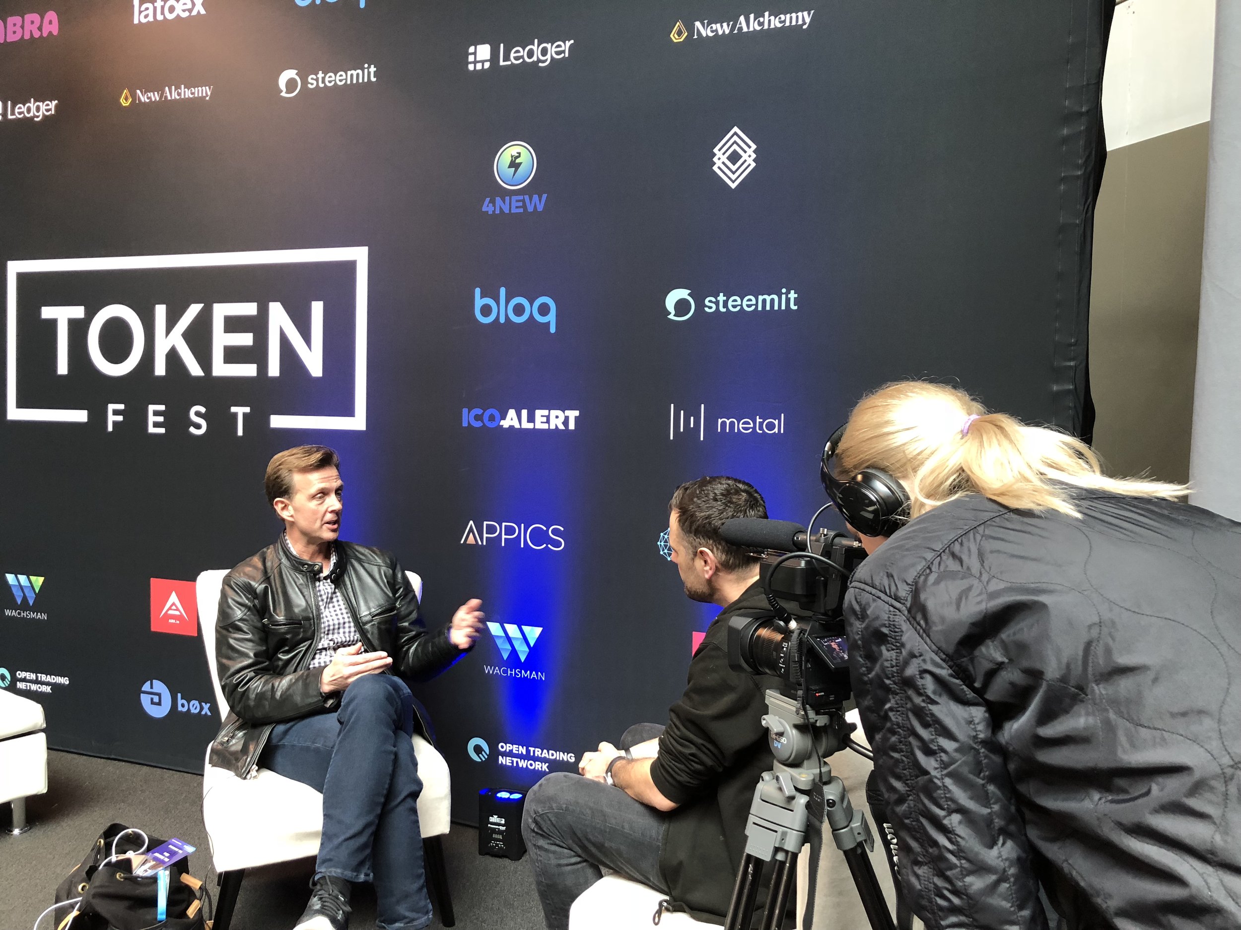 A television crew records an interview at Token Fest