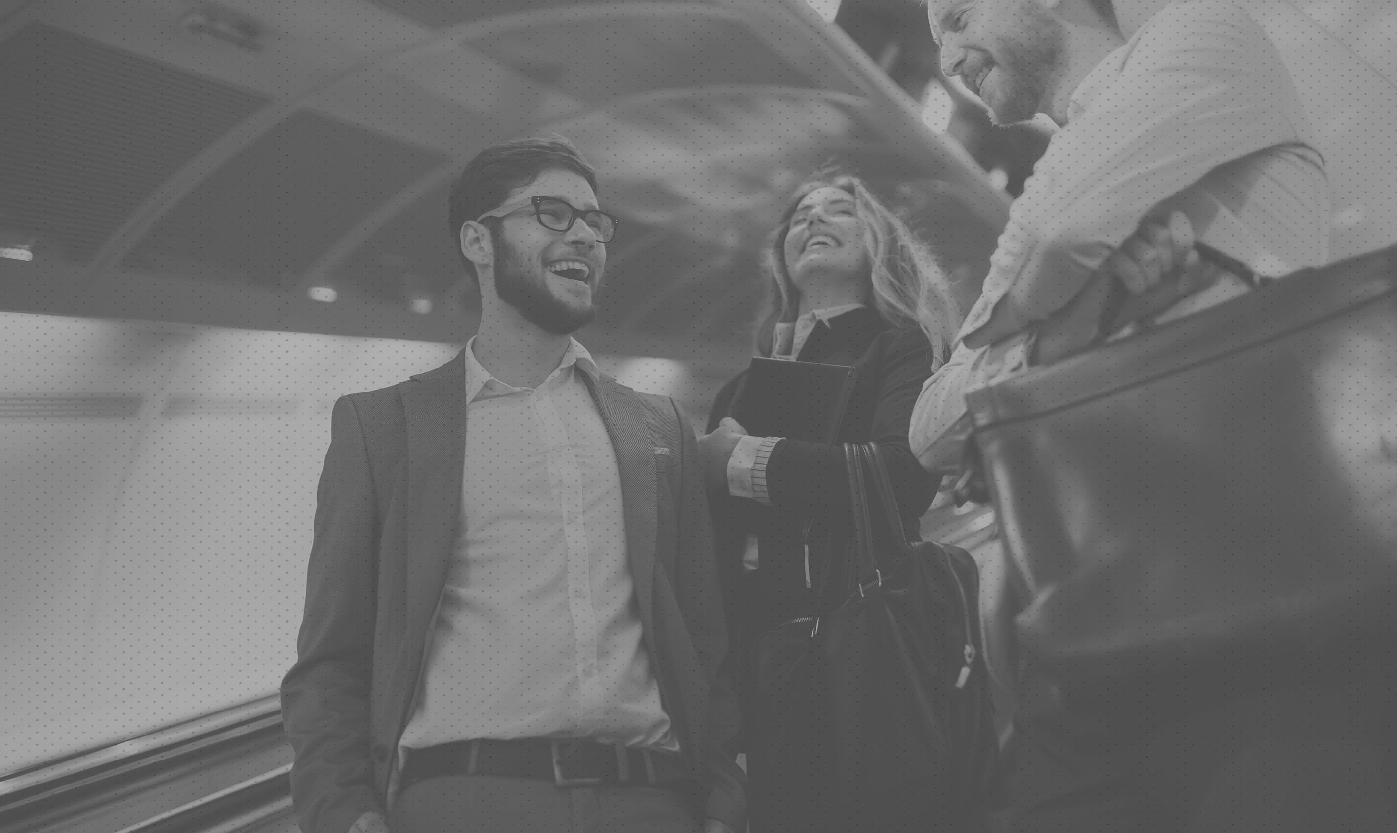 Three businesspeople in conversation, pictured on AgileOne's careers page