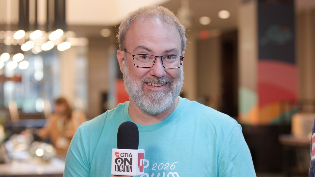 Aharon Chernin holding a GTIA microphone during an interview at FLOW 2026