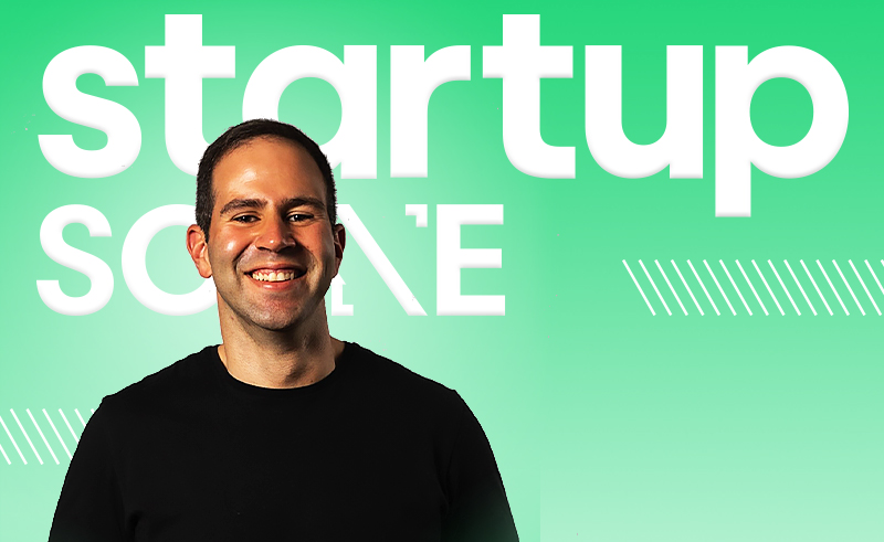 Ahmed Ashour smiling in front of a StartupScene backdrop