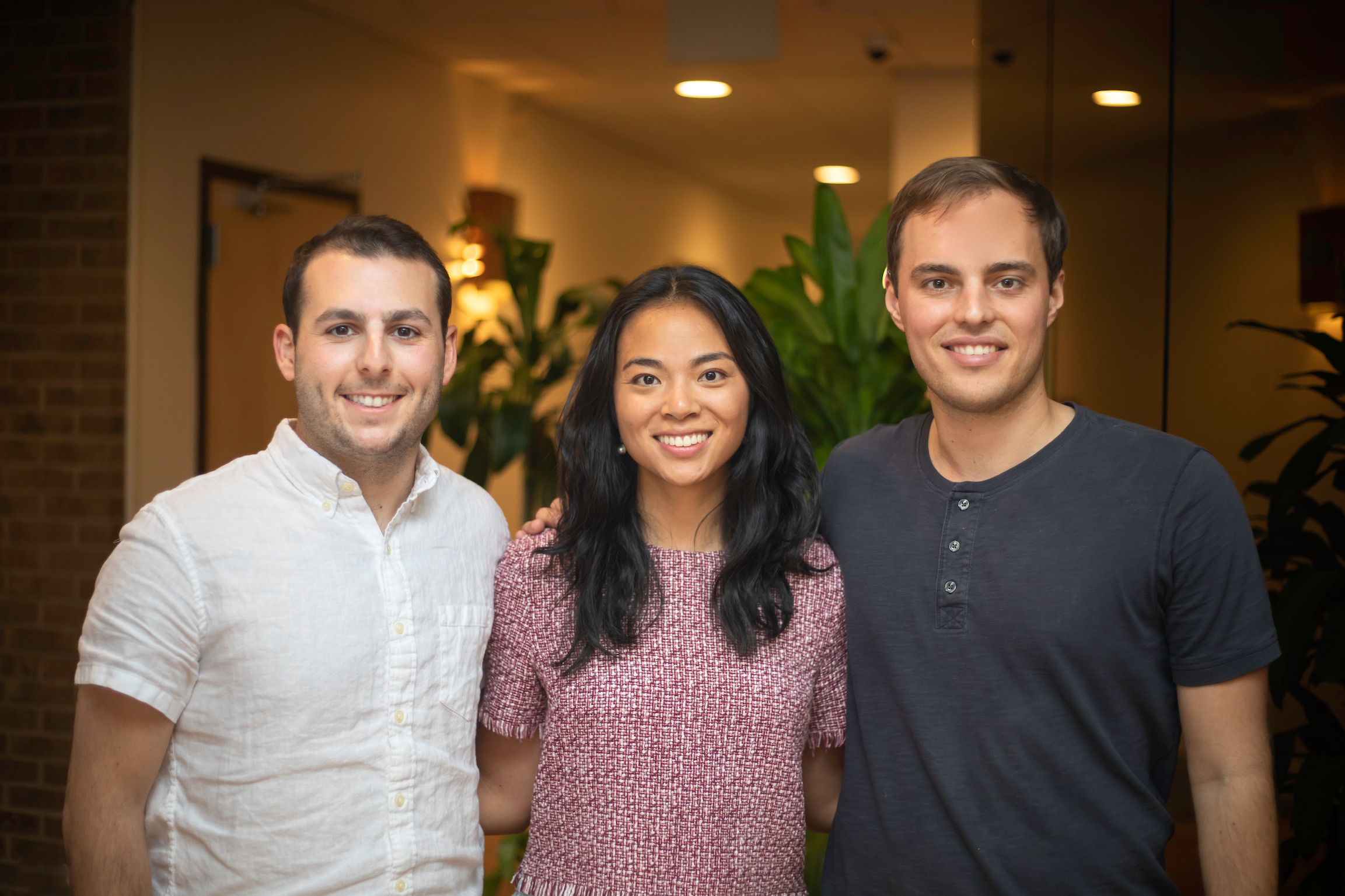 Nourish co-founders Sam Perkins, Stephanie Liu and Aidan Dewar standing together in an office