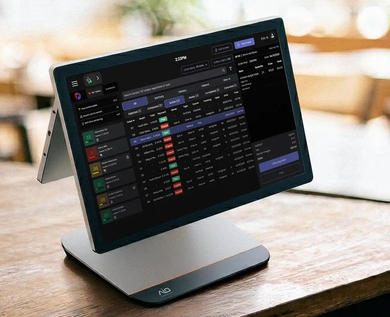 AIO point-of-sale terminal showing restaurant orders and payment status