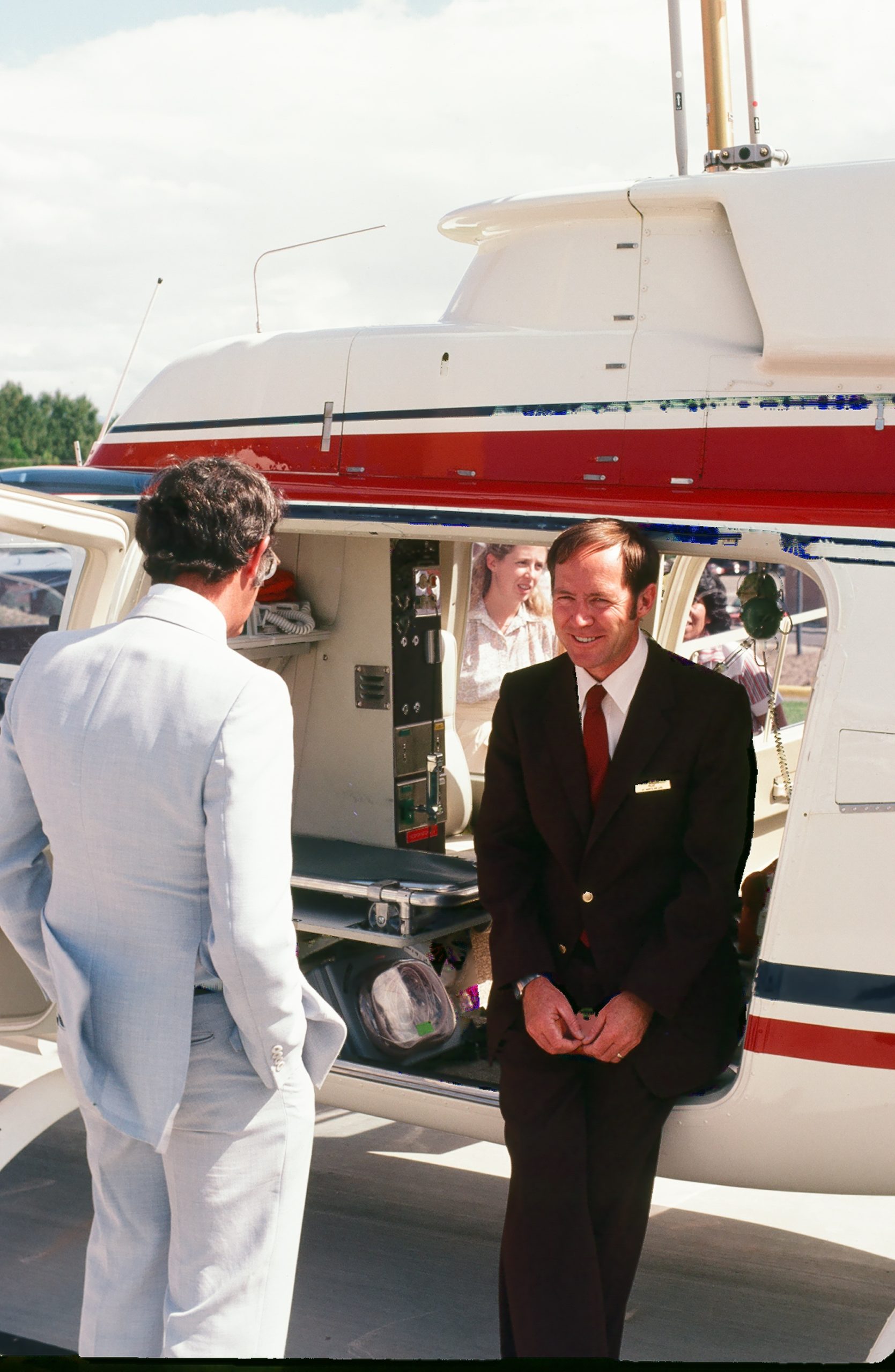 Air Methods founder Roy Morgan seated at the open doorway of a medical helicopter
