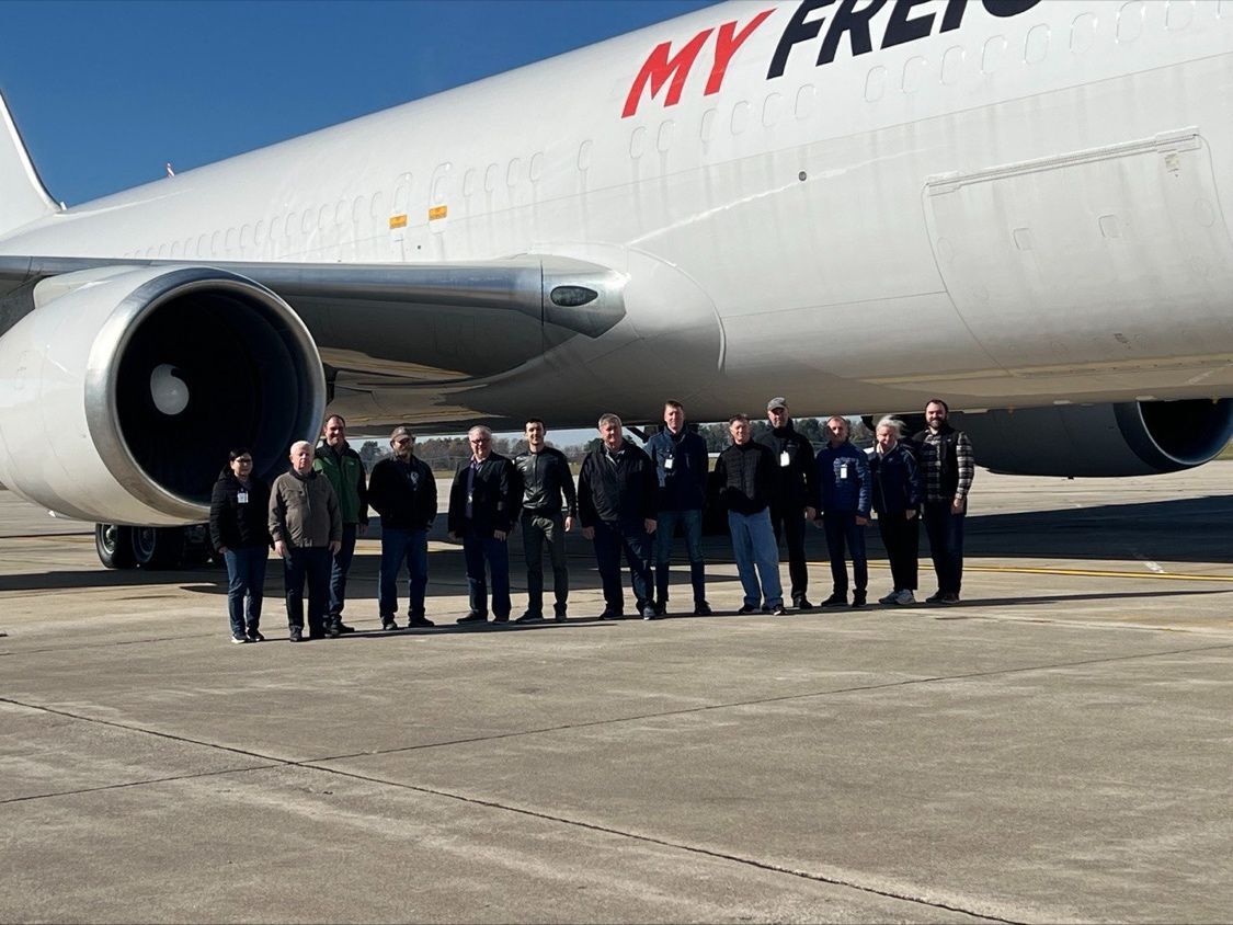 ATSG and My Freighter representatives standing beside a Boeing 767 at a 2023 aircraft handover