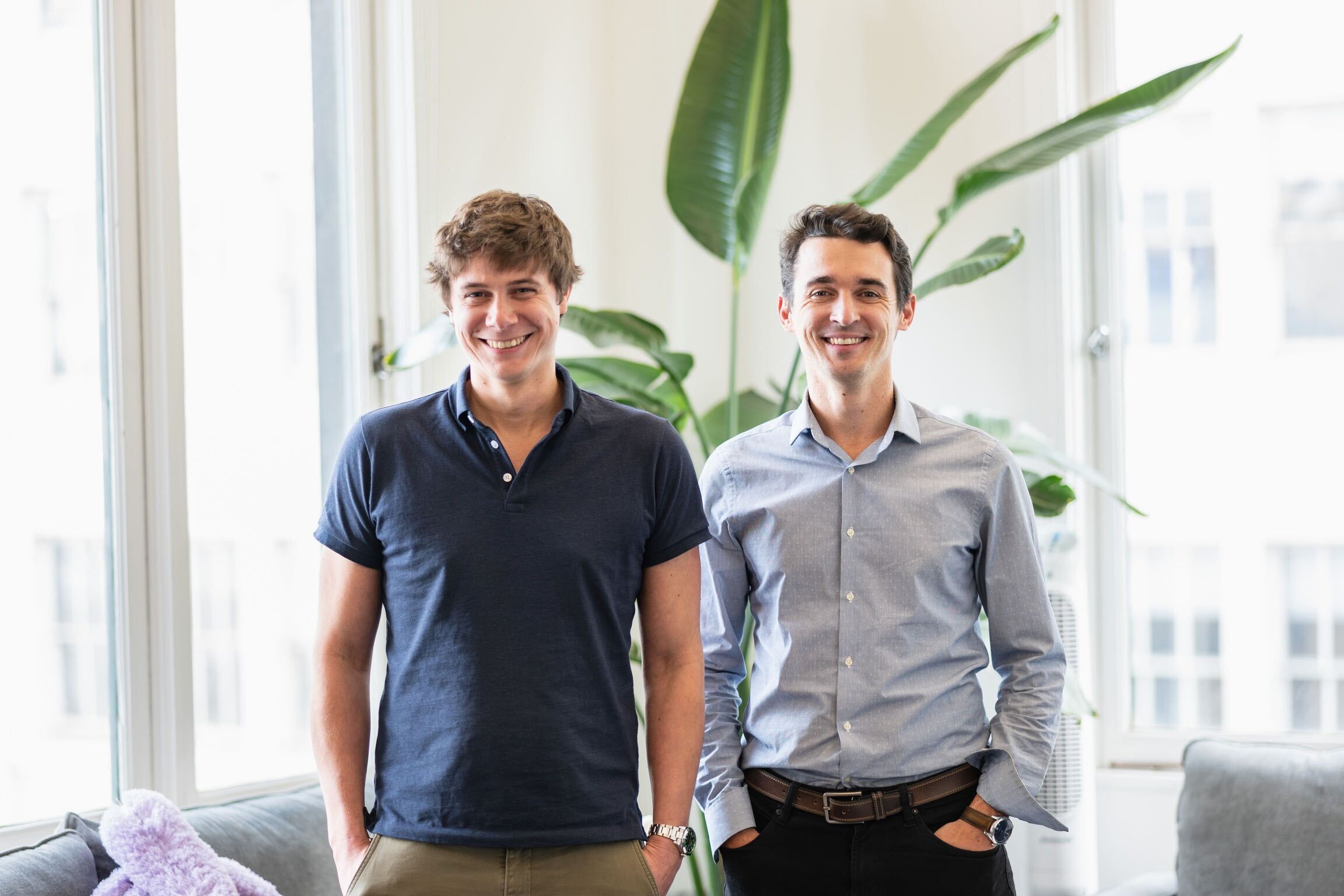 Airbyte co-founders Michel Tricot and Jean Lafleur standing together in a bright room