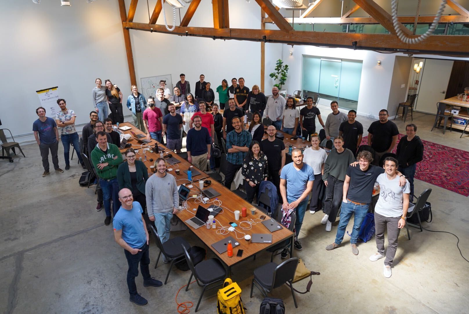 Airbyte team gathered around long tables in a San Francisco workspace