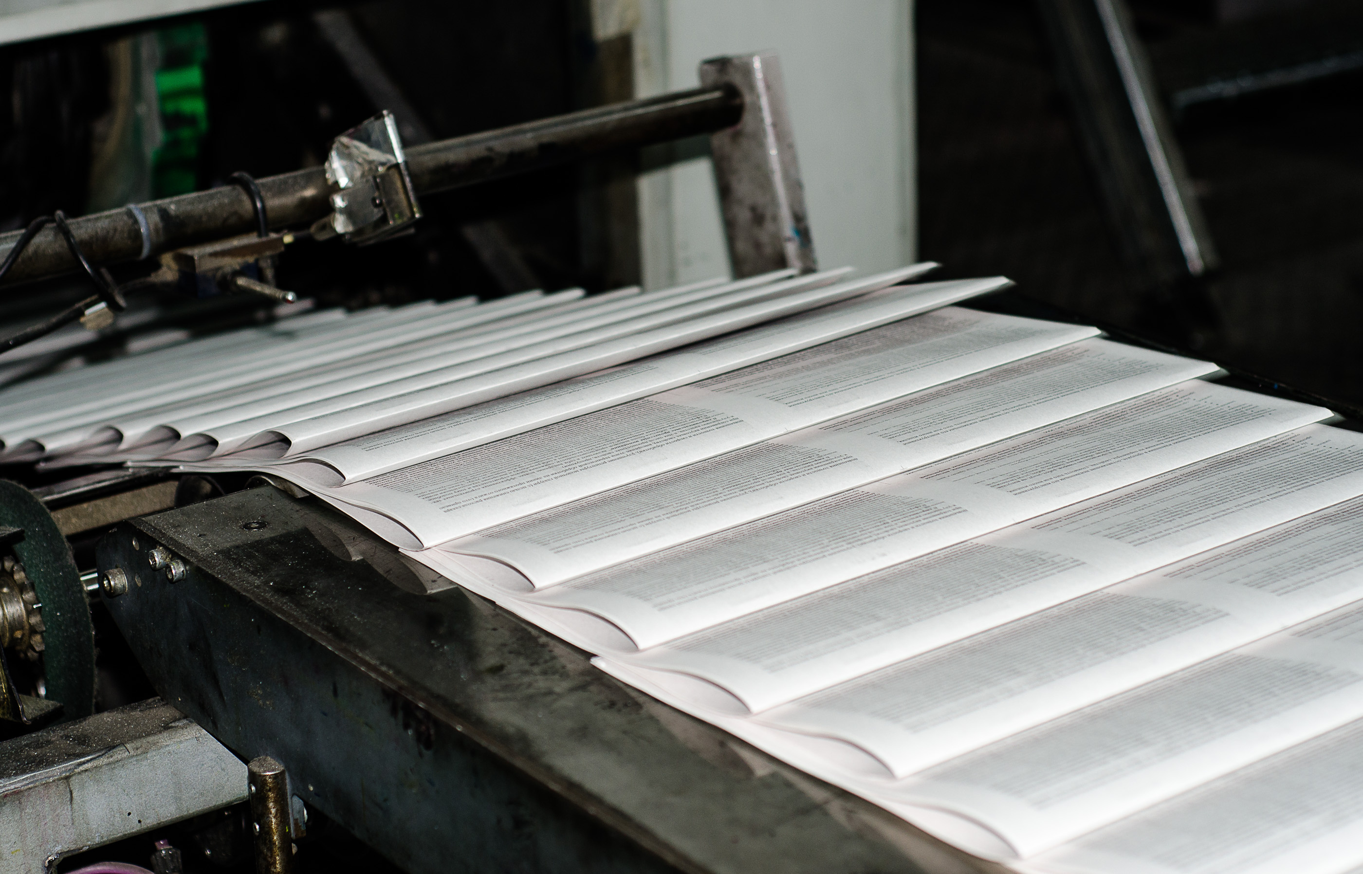 Sheets moving through an industrial printing press