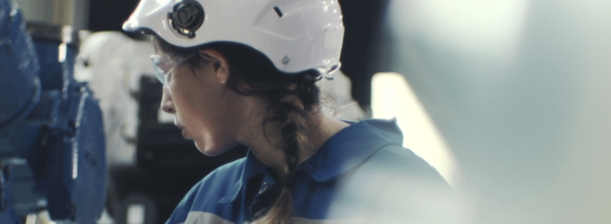 An AirMyne engineer in a hard hat working amid direct air capture equipment
