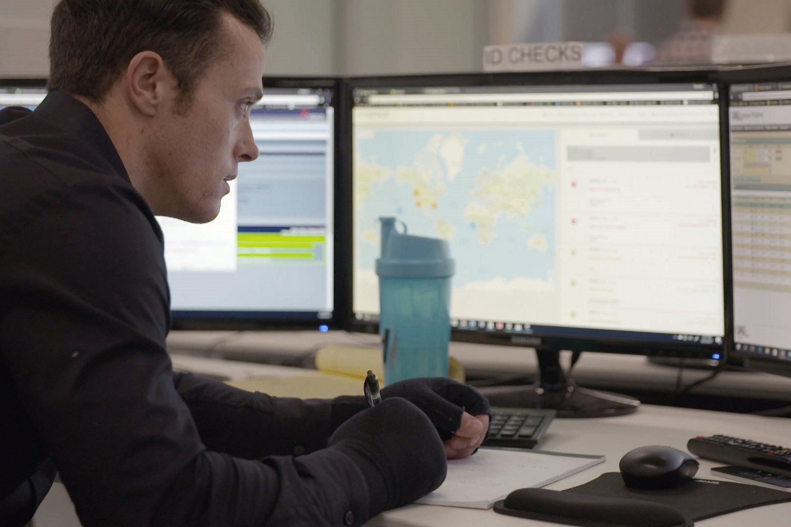 An Airspace operations employee studies shipment information across several monitors
