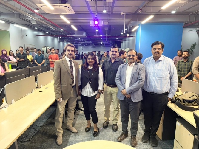 Colleagues gathered between desks for AIT Global India’s Foundation Day celebration