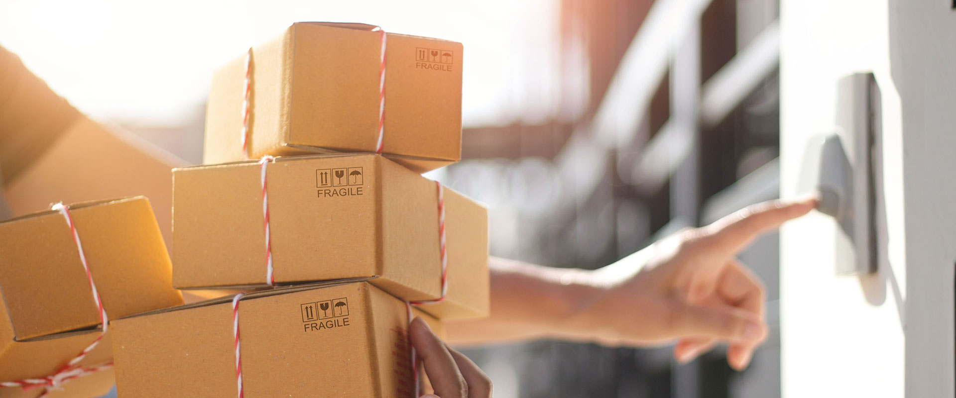 Boxes marked fragile carried toward a residential door