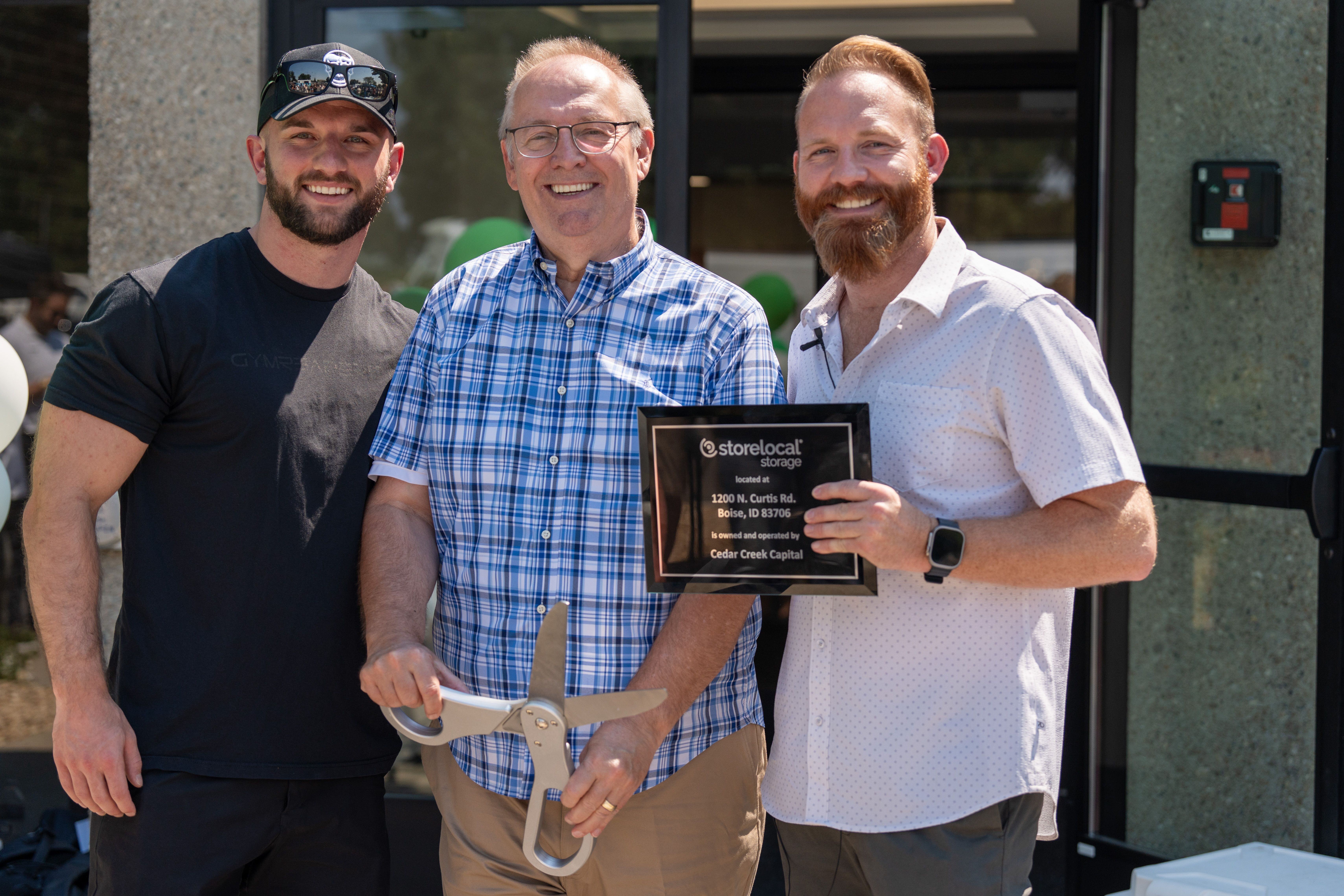 AJ Osborne, at right, with Ron Osborne and another participant at a Storelocal Storage ribbon cutting
