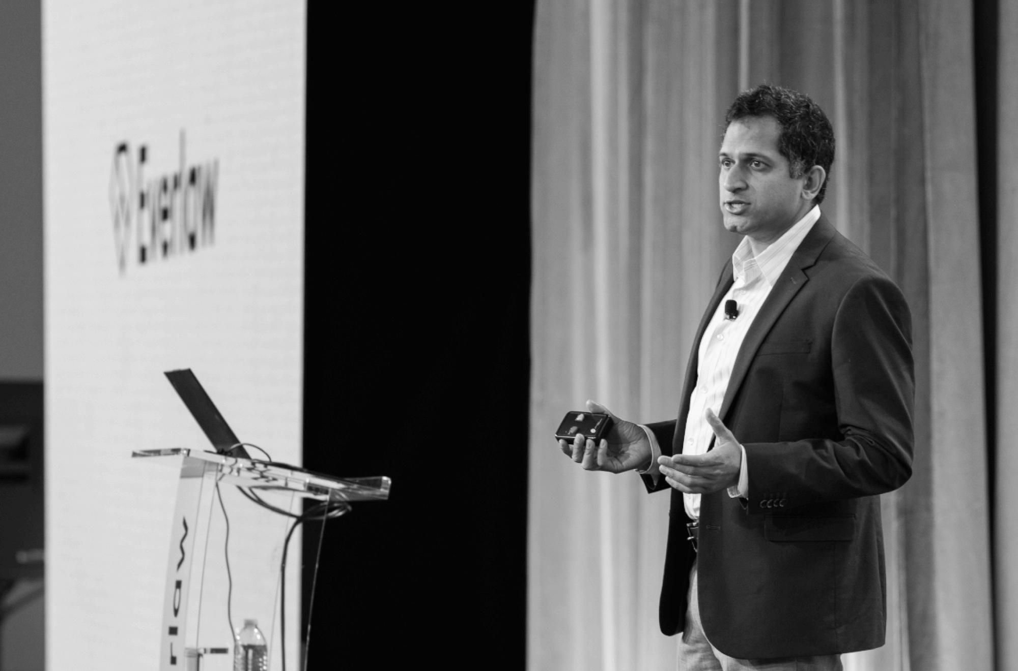 AJ Shankar speaking beside a lectern at an Everlaw event