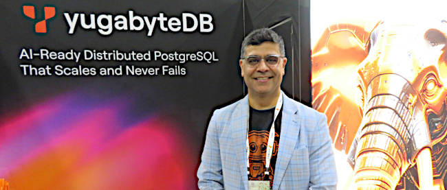 Ajay Khanna standing at the YugabyteDB booth during KubeCon North America 2025