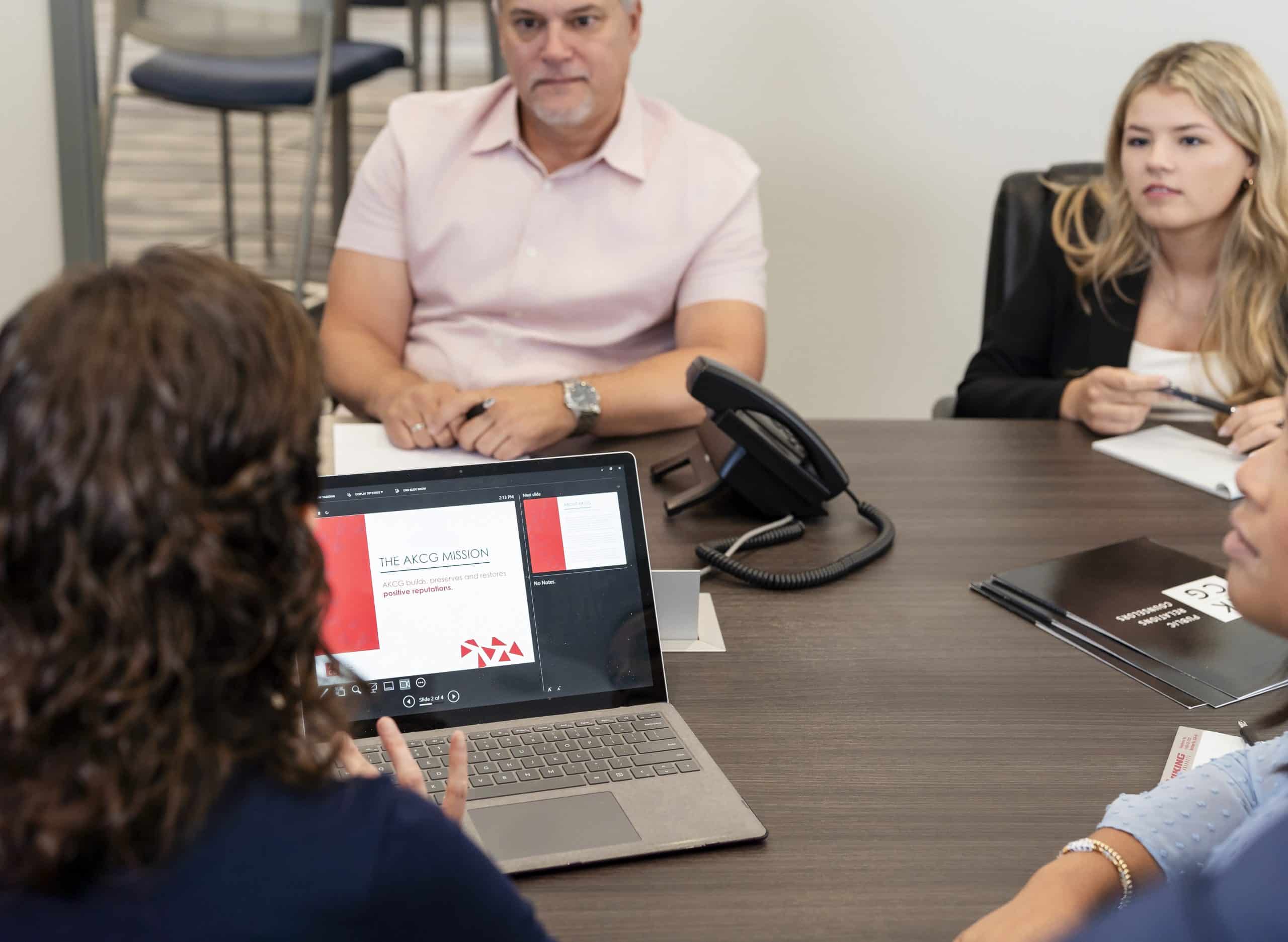 AKCG team members gathered in a modern office