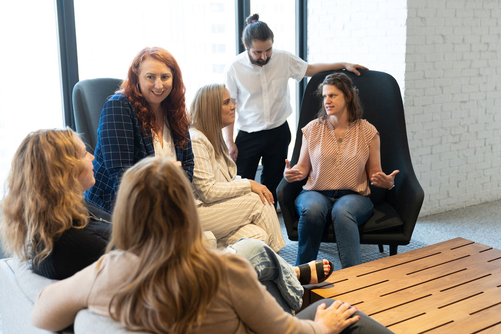 Akrete colleagues gathered in conversation around a low table