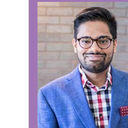 Akshay Budhkar wearing glasses and a blue jacket during his Toronto research years