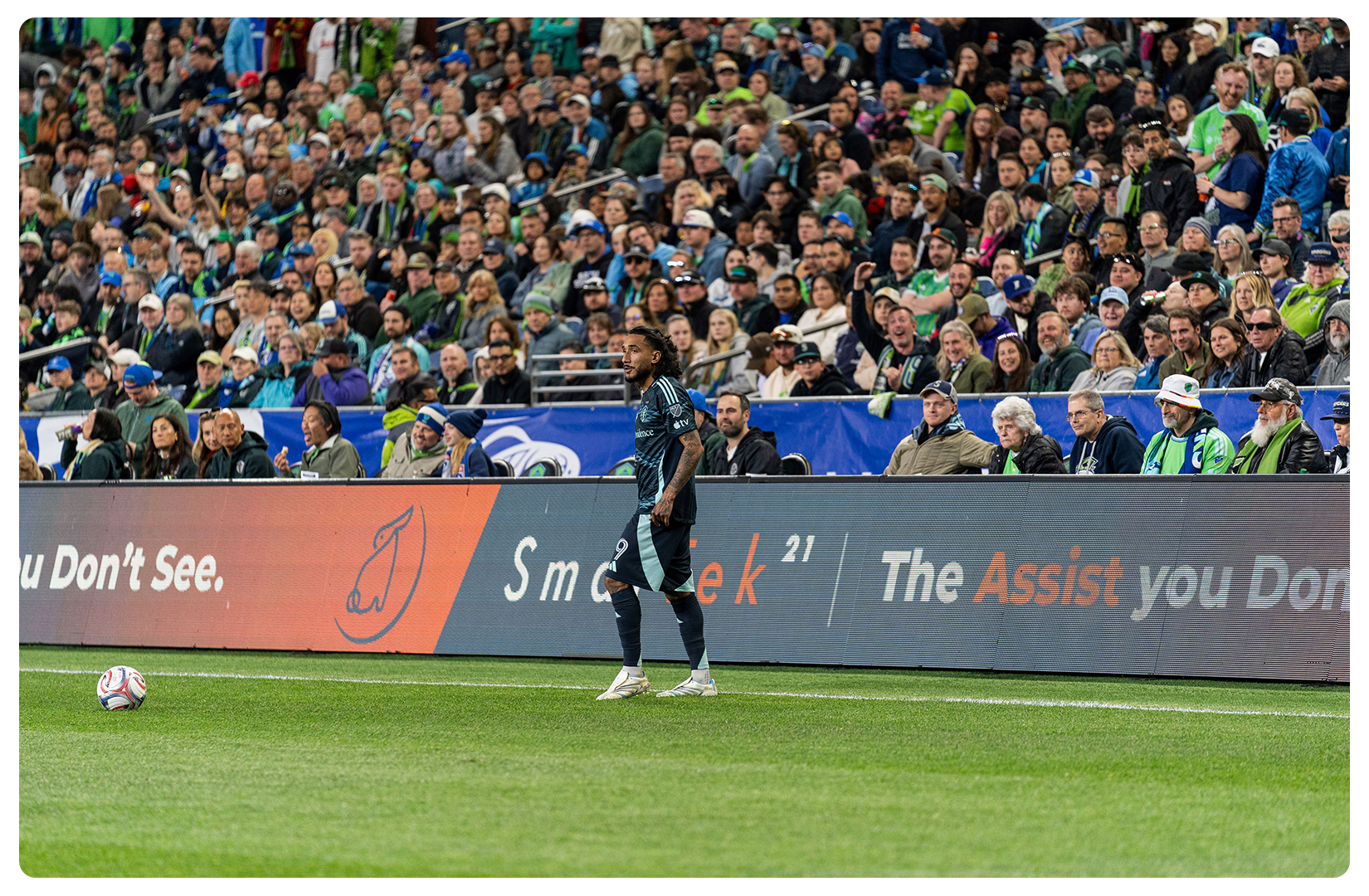 Seattle Sounders match with SmarTek21 branding on the pitch-side advertising board