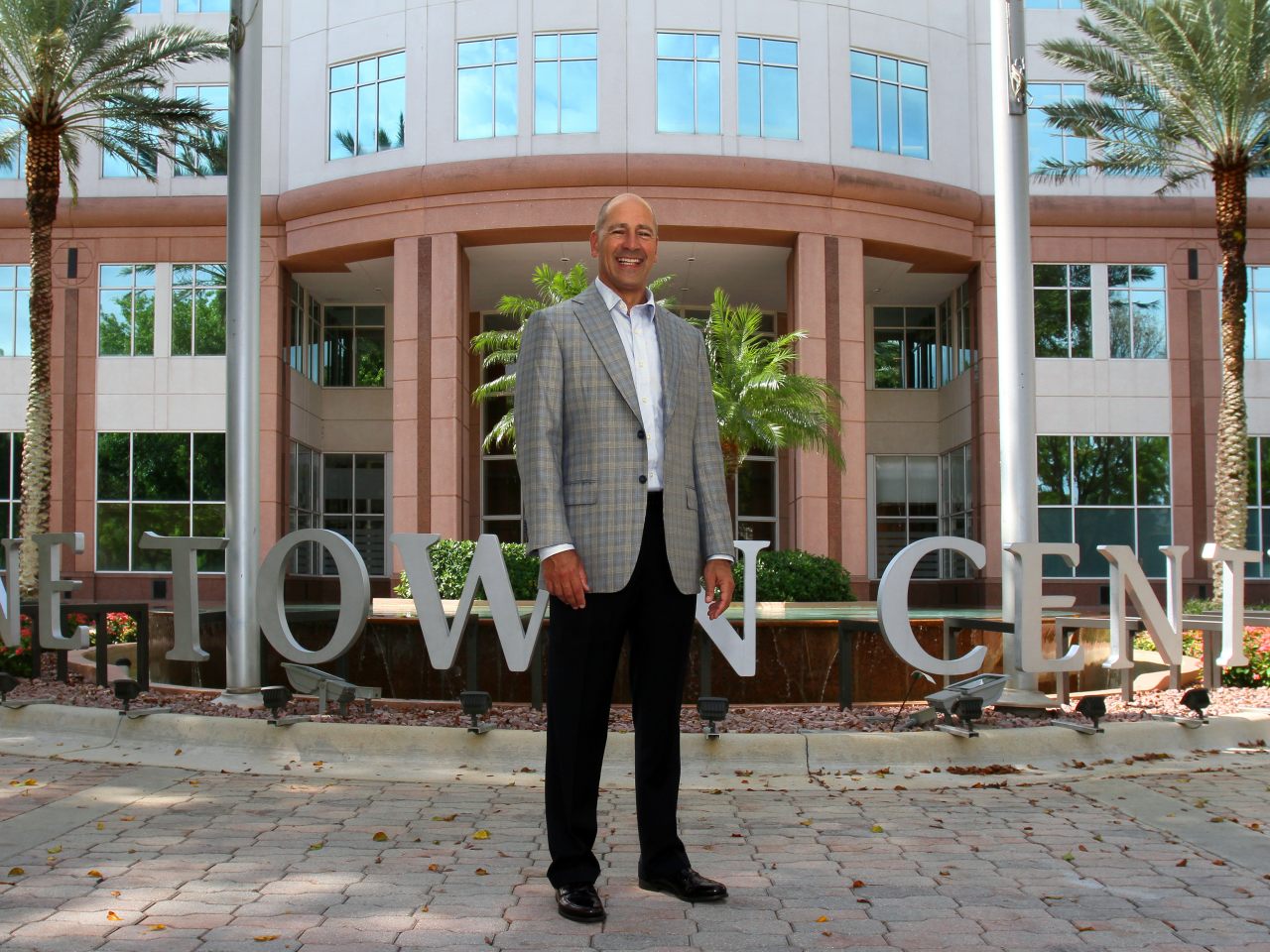 Al Rabil standing outside One Town Center in a checked jacket