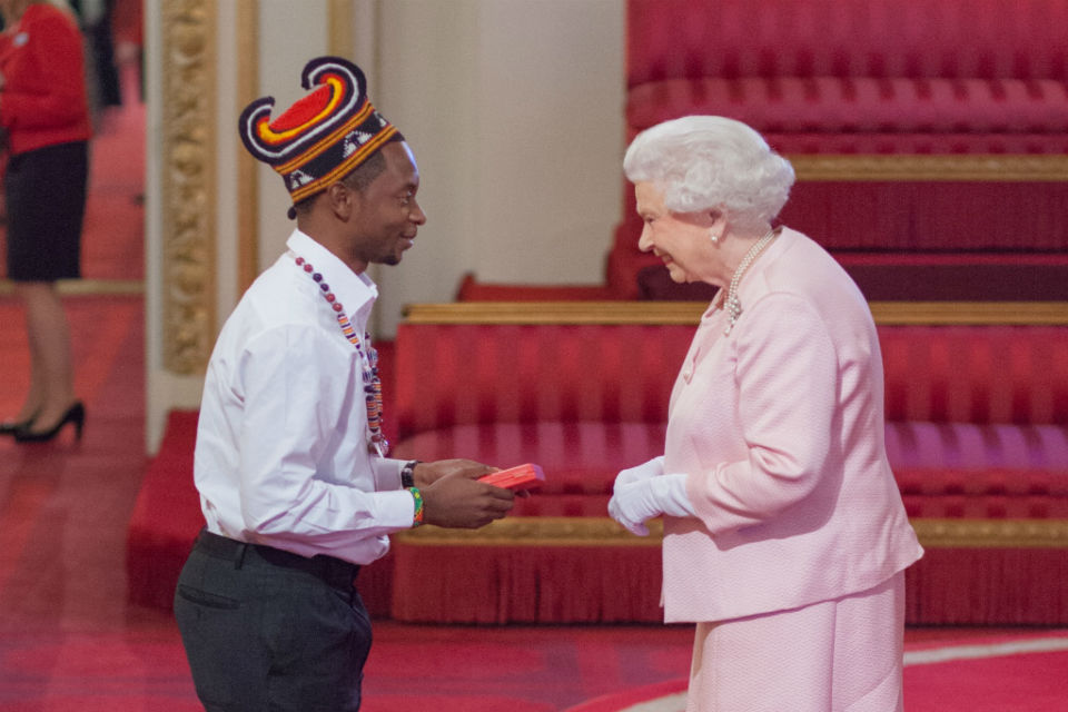 Alain Nteff receiving a Queen's Young Leader Award from Queen Elizabeth II at Buckingham Palace in 2015