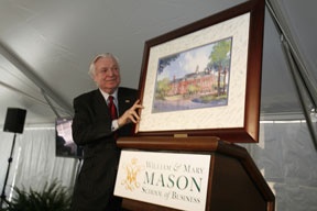 Alan B. Miller holding a framed rendering of the planned business school building at William and Mary
