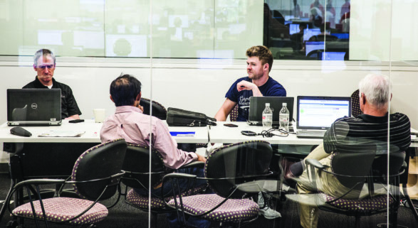 AirWatch employees working around a conference table in a glass-walled Atlanta office