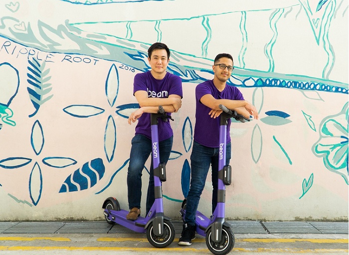 Alan Jiang on the left and Beam co-founder Deb Gangopadhyay on the right, standing with purple scooters