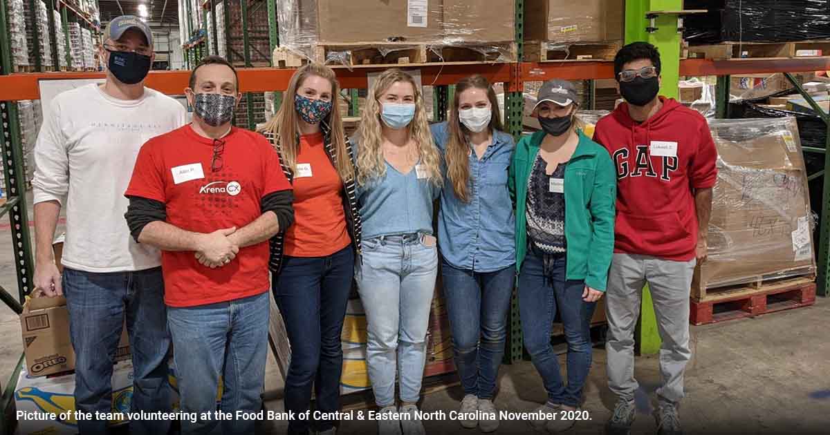 Alan Pendleton and ArenaCX colleagues volunteering in a food bank warehouse in 2020
